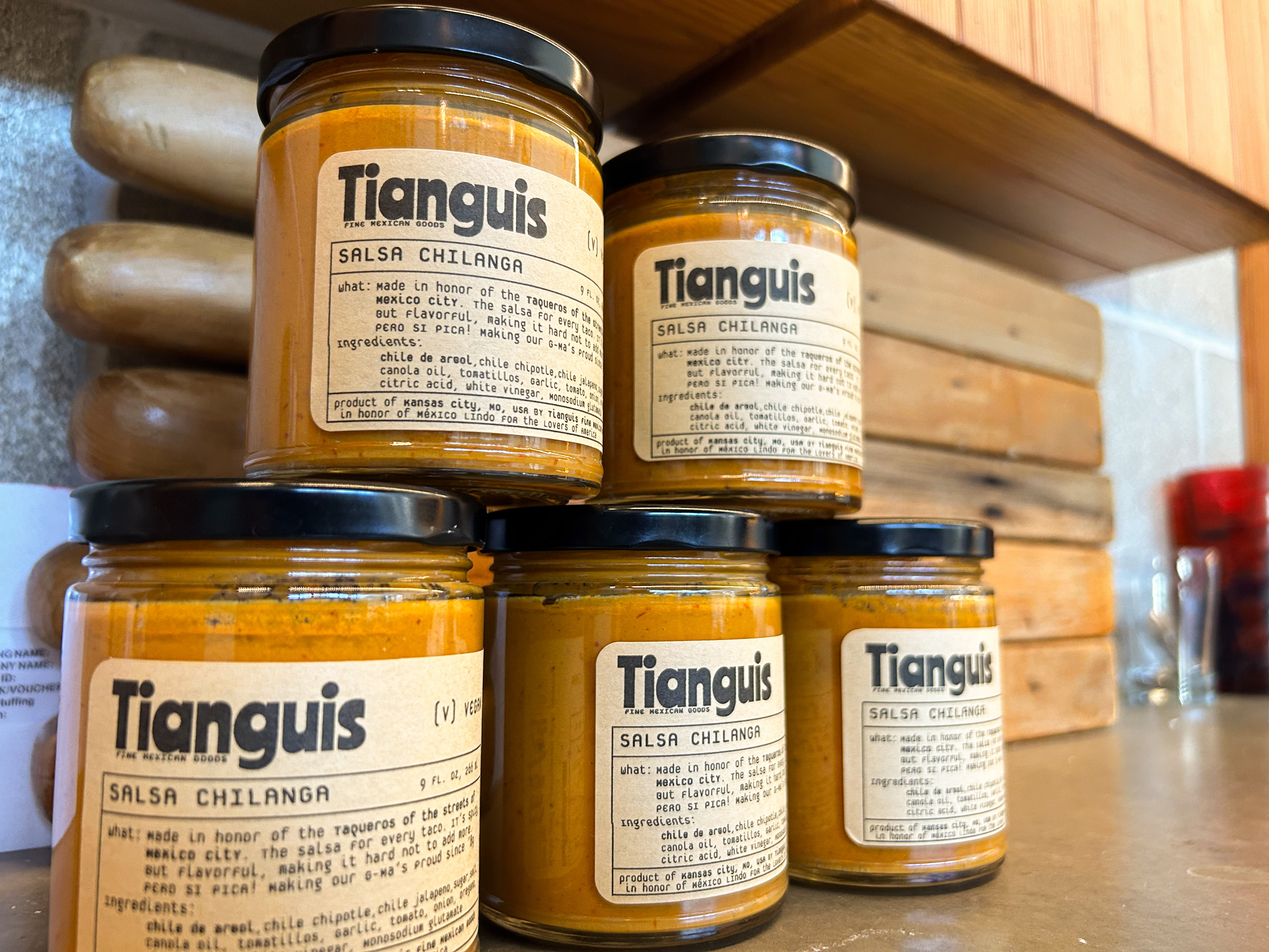 four jars of tanguis chutney sitting on a counter